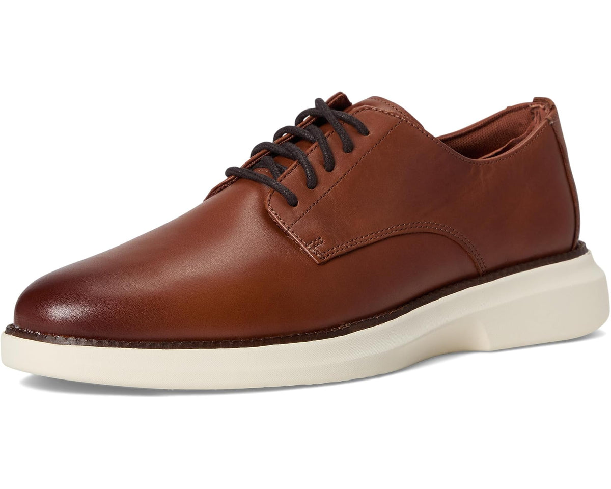 Brown plain-toe Oxford shoes with lace-up front and cream cushioned sole