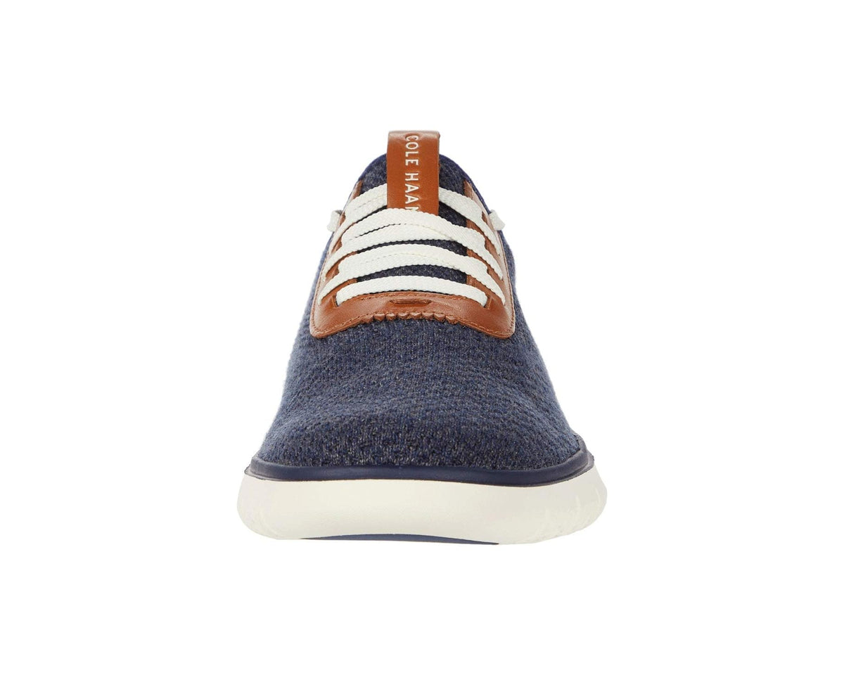 Navy knit front view of men's sneakers with tan leather laces and white sole