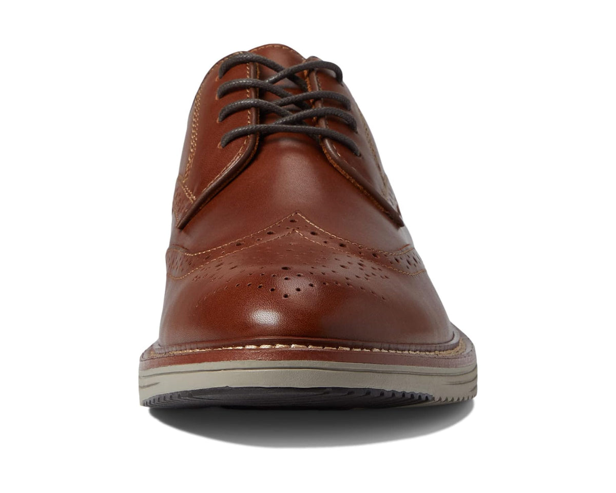 Men's tan oxford dress shoe front view with lace-up closure and wingtip stitching