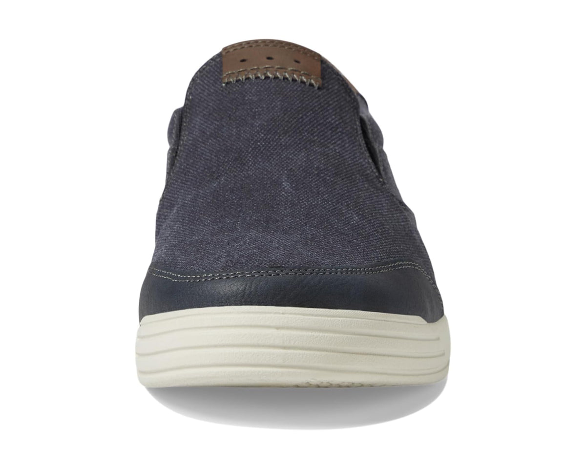 Dark blue canvas slip-on shoe with moc seam at heel and off-white midsole