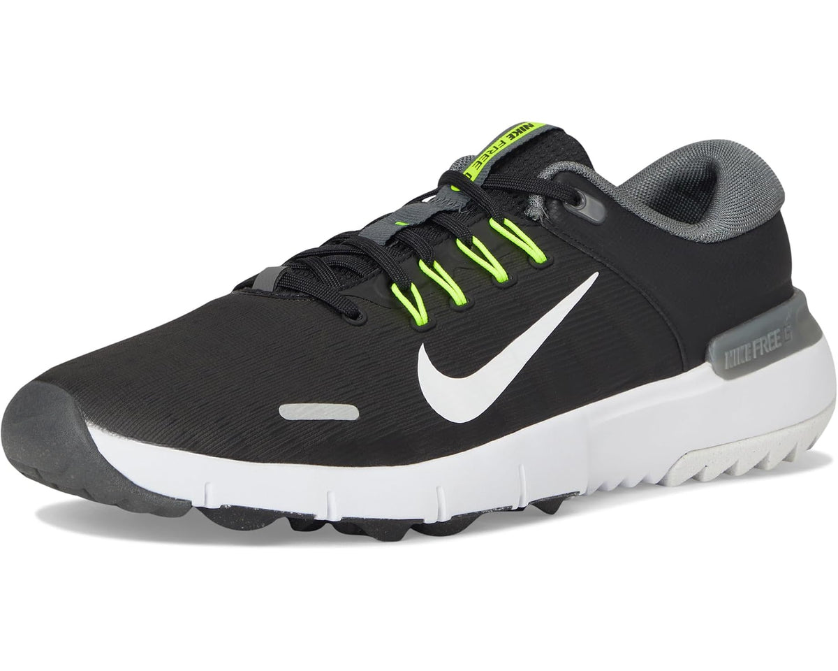 Nike golf shoe front view, black upper with white sole and neon green lace details.
