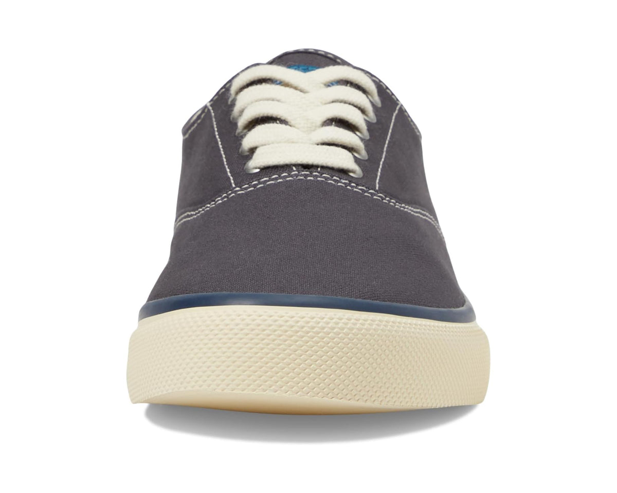 Navy canvas sneaker with cream laces and low-profile textured rubber sole