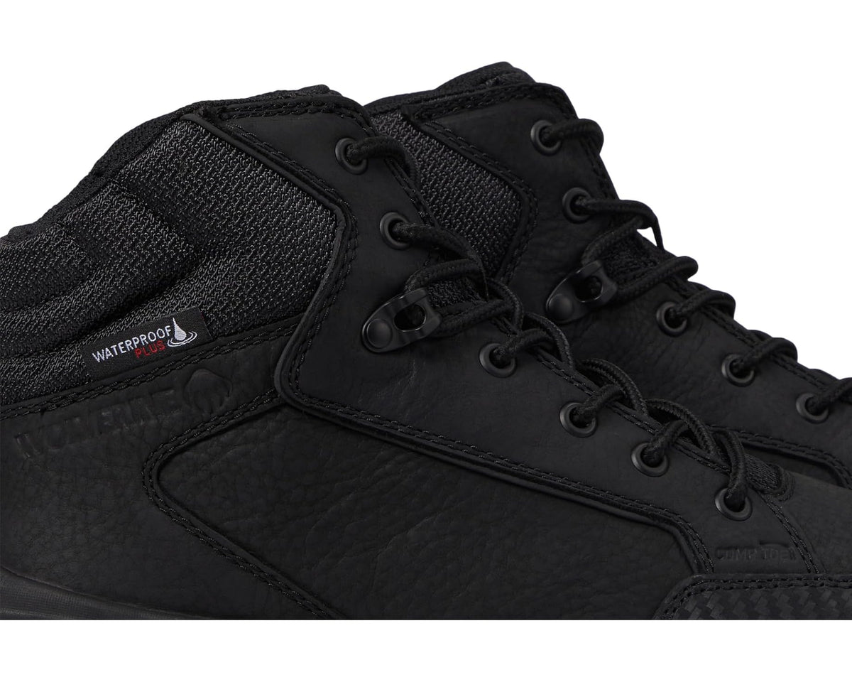 Black waterproof work boot detail: laces, metal eyelets, textured upper panel