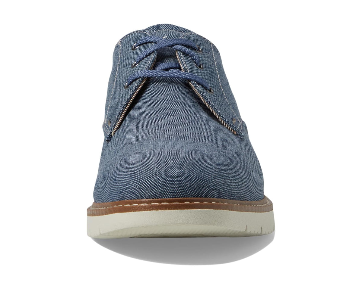 Men's blue canvas oxford shoes with lace-up front and rubber sole, side view