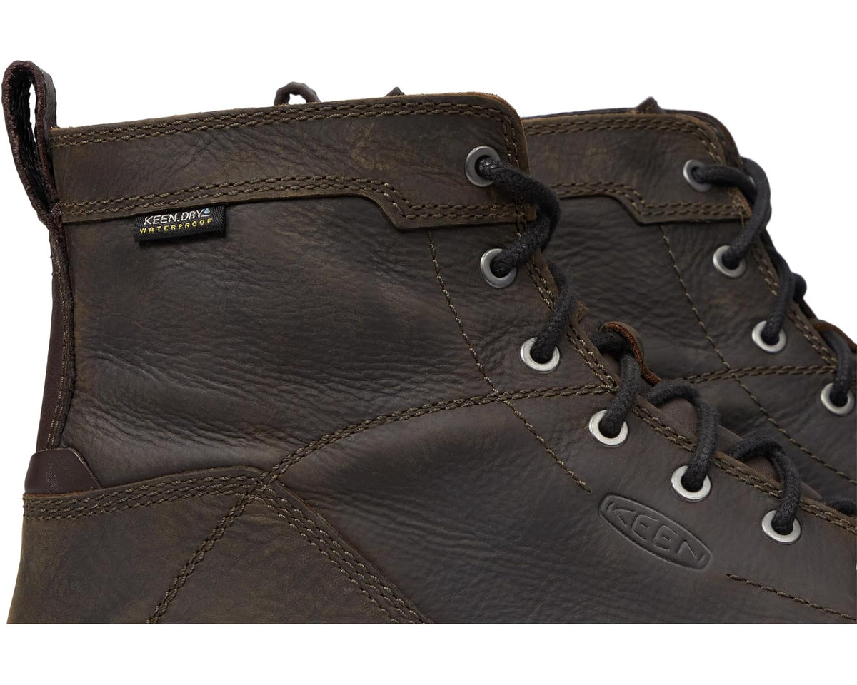 Close-up of brown waterproof work boot upper with KEEN logo and laces