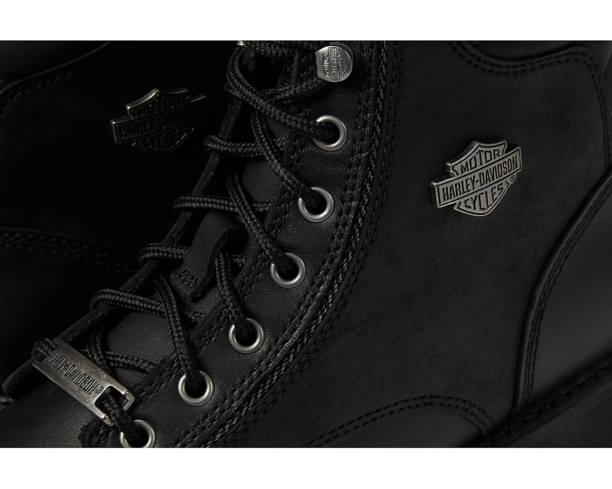 Close-up of black boot laces, metal eyelets, and Harley-Davidson logo patch
