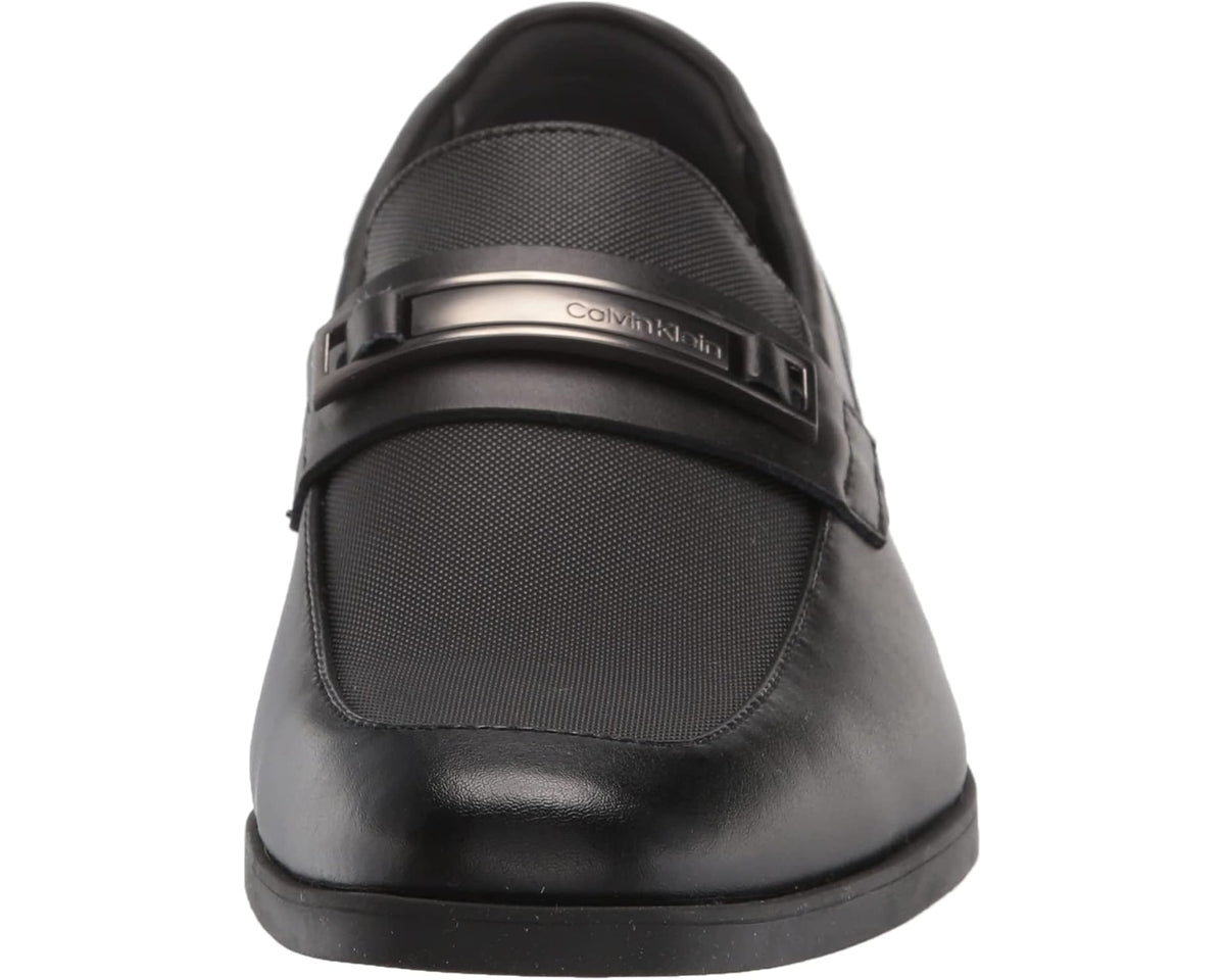 Black loafer front view with Calvin Klein logo buckle and textured toe
