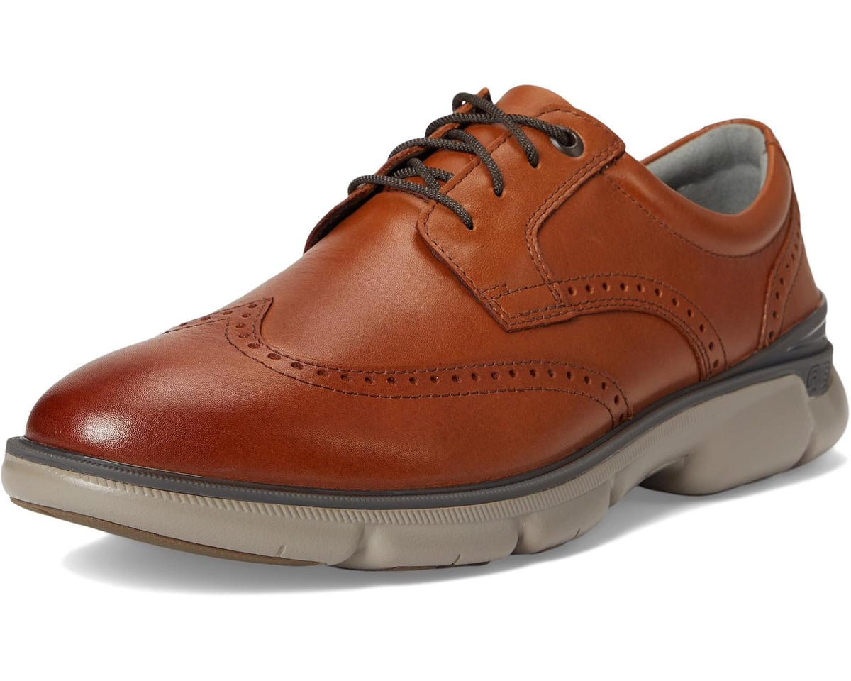 Tan leather oxford lace-up with wingtip perforations and chunky rubber sole