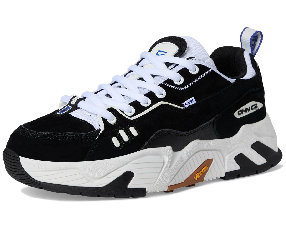 Black and white athletic sneakers with white laces, blue tag, and chunky sole