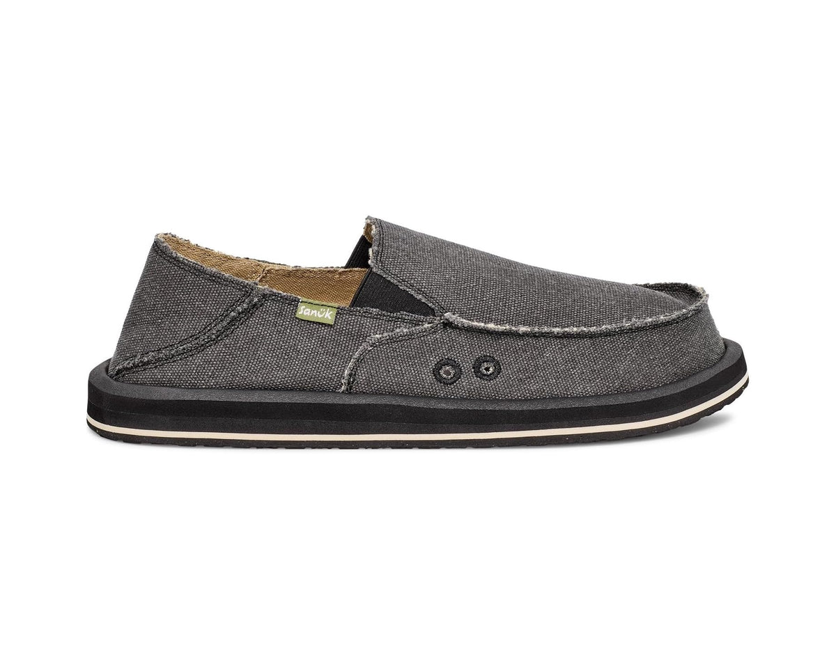 Charcoal slip-on shoes front view with tan interior, stitched seams, and logo patch