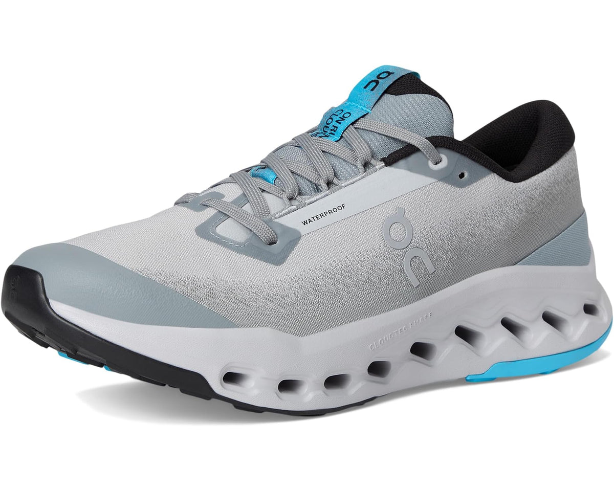Light gray waterproof trail running shoe with blue lace loops and rubber sole