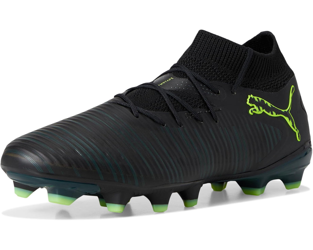 Black soccer cleats with green PUMA logo, firm-ground studs, ribbed synthetic upper