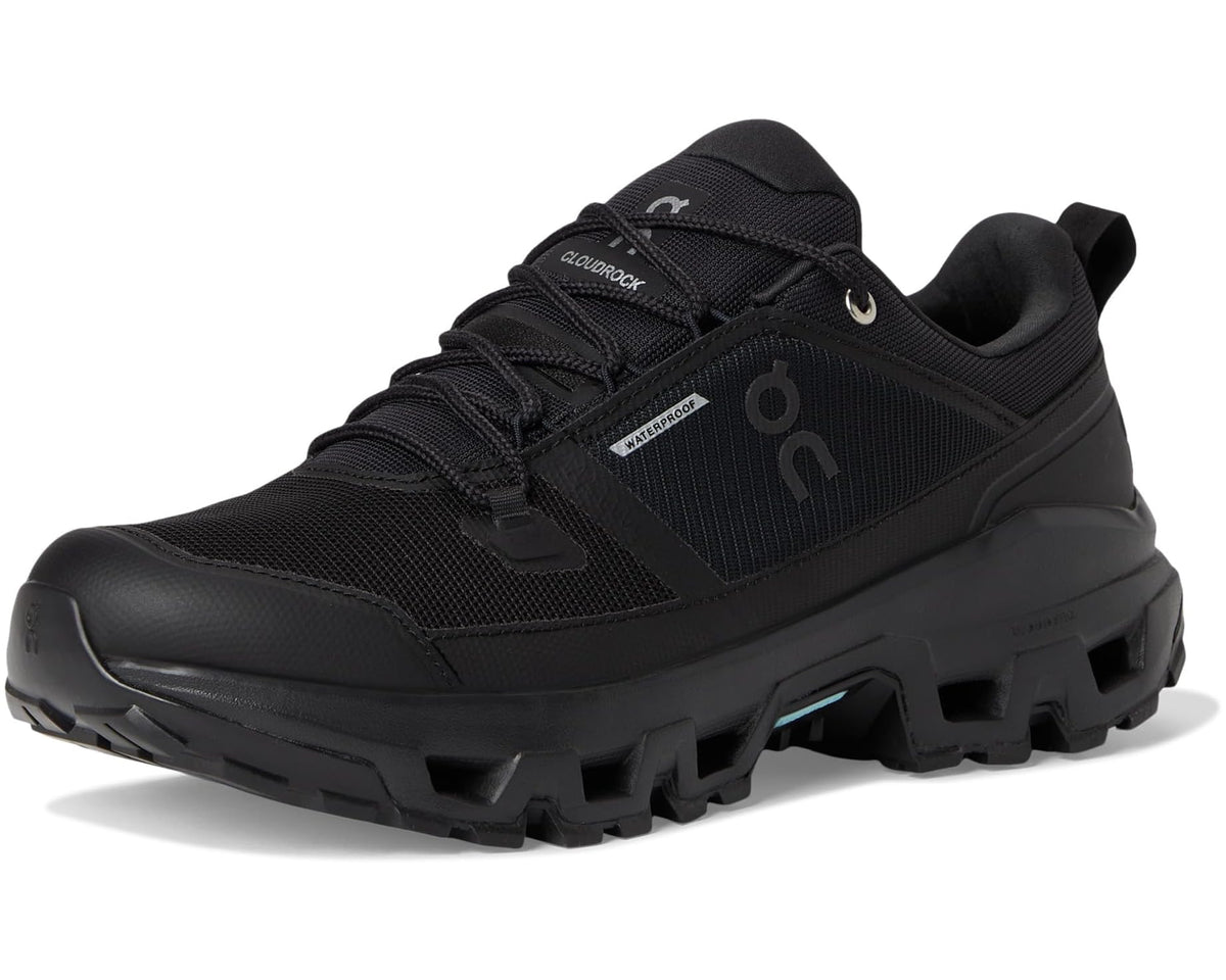 Men's black low-top waterproof trail shoe, front three-quarter view with chunky outsole