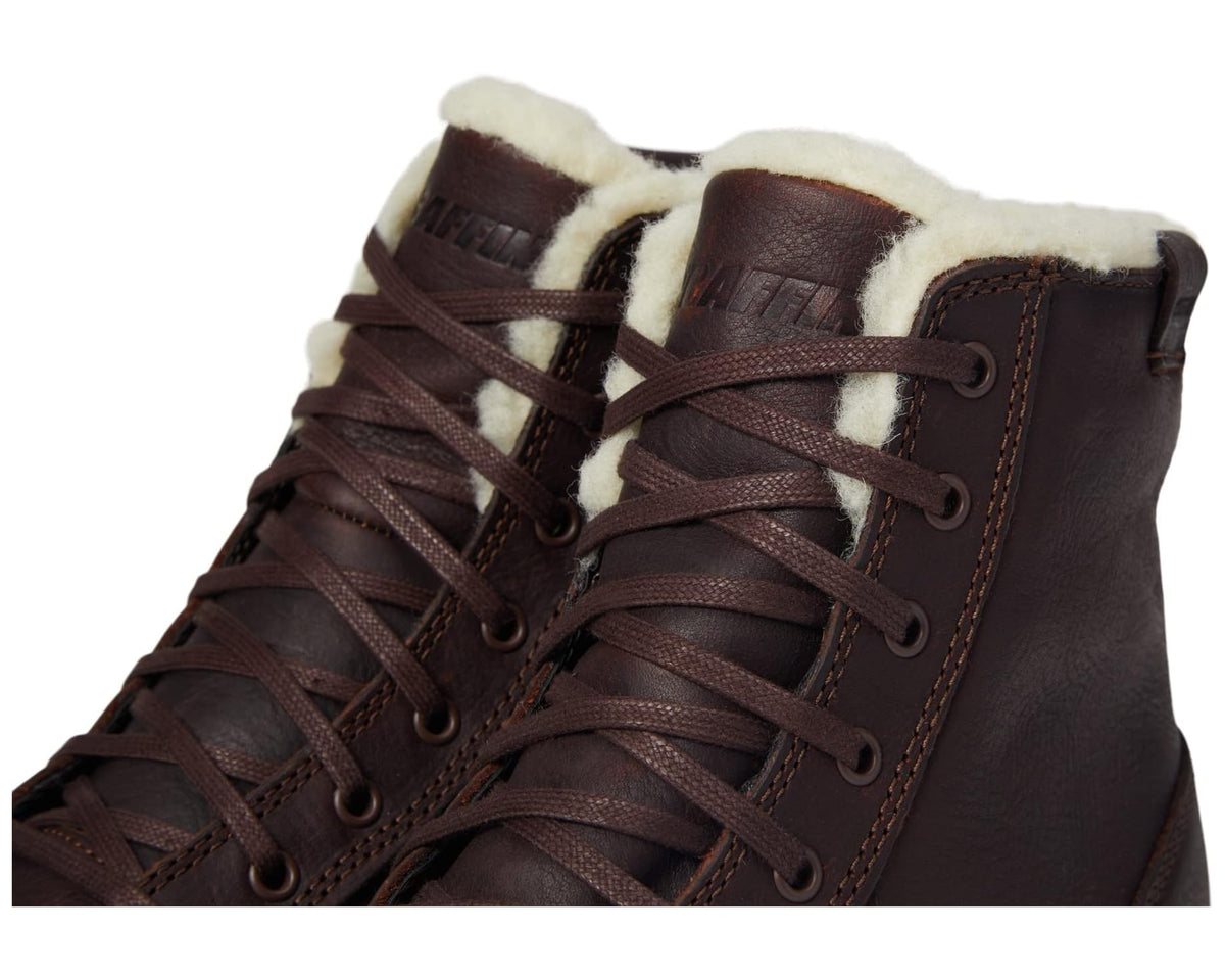 Close-up of brown lace-up boots with fur lining and stitched leather upper