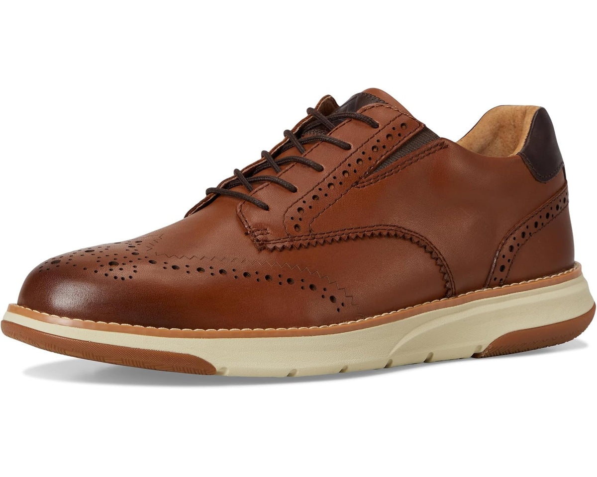 Tan/brown leather lace-up oxford sneaker with brogue perforations, cushioned collar, and rubber sole