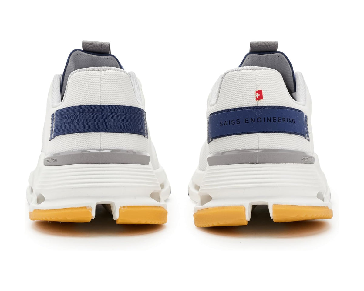 Men's heel view: navy-striped collar, Swiss Engineering logo patch, and orange outsole