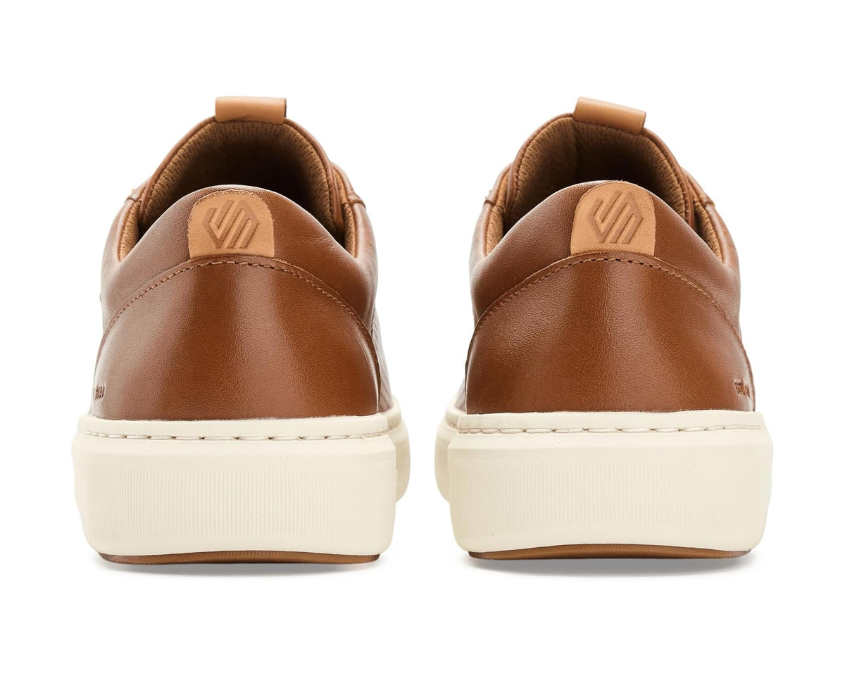 Tan leather low-top sneakers with heel tabs and cream midsoles, back view pair