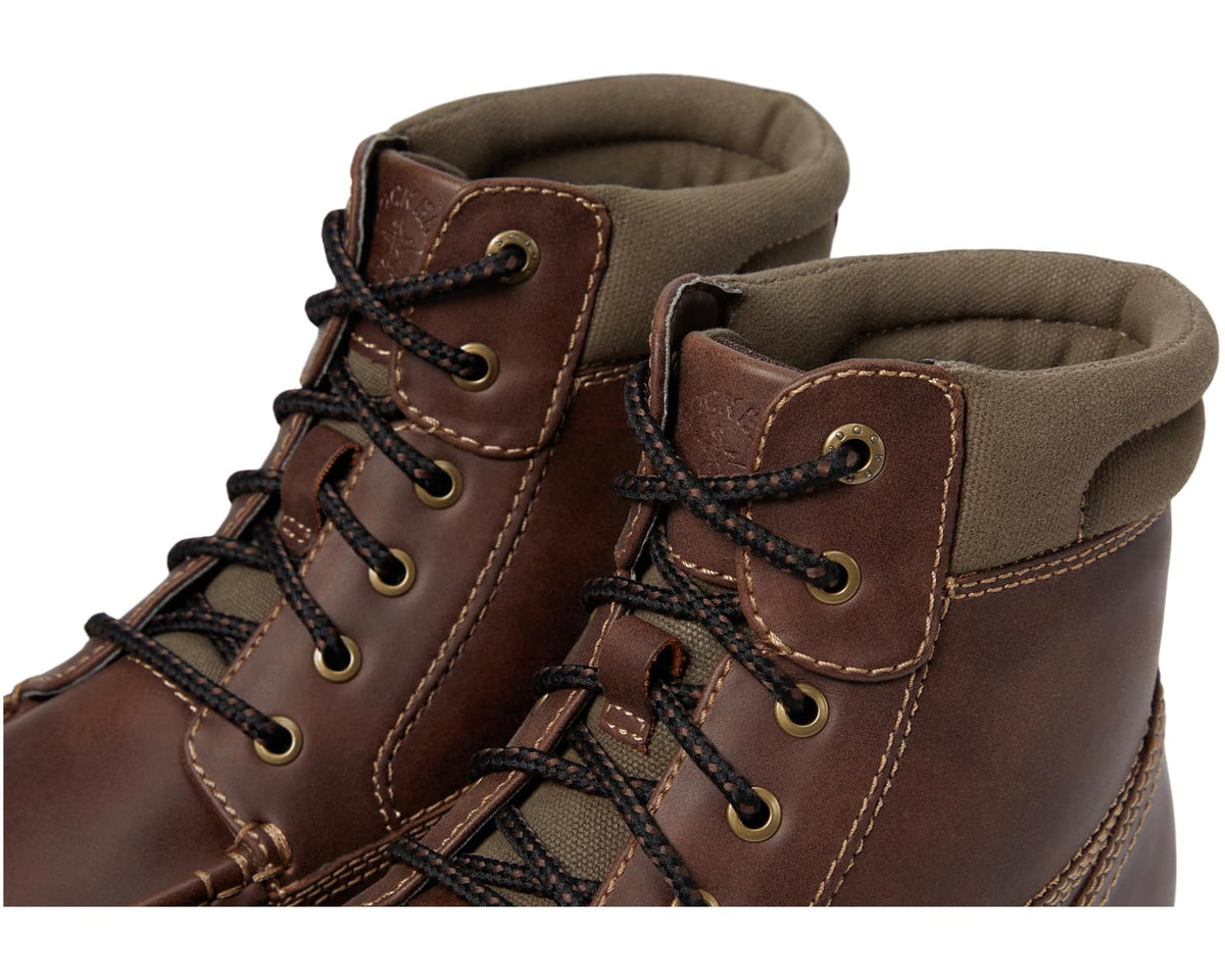 Brown boot upper close-up with lace eyelets, stitching, and fabric-lined collar