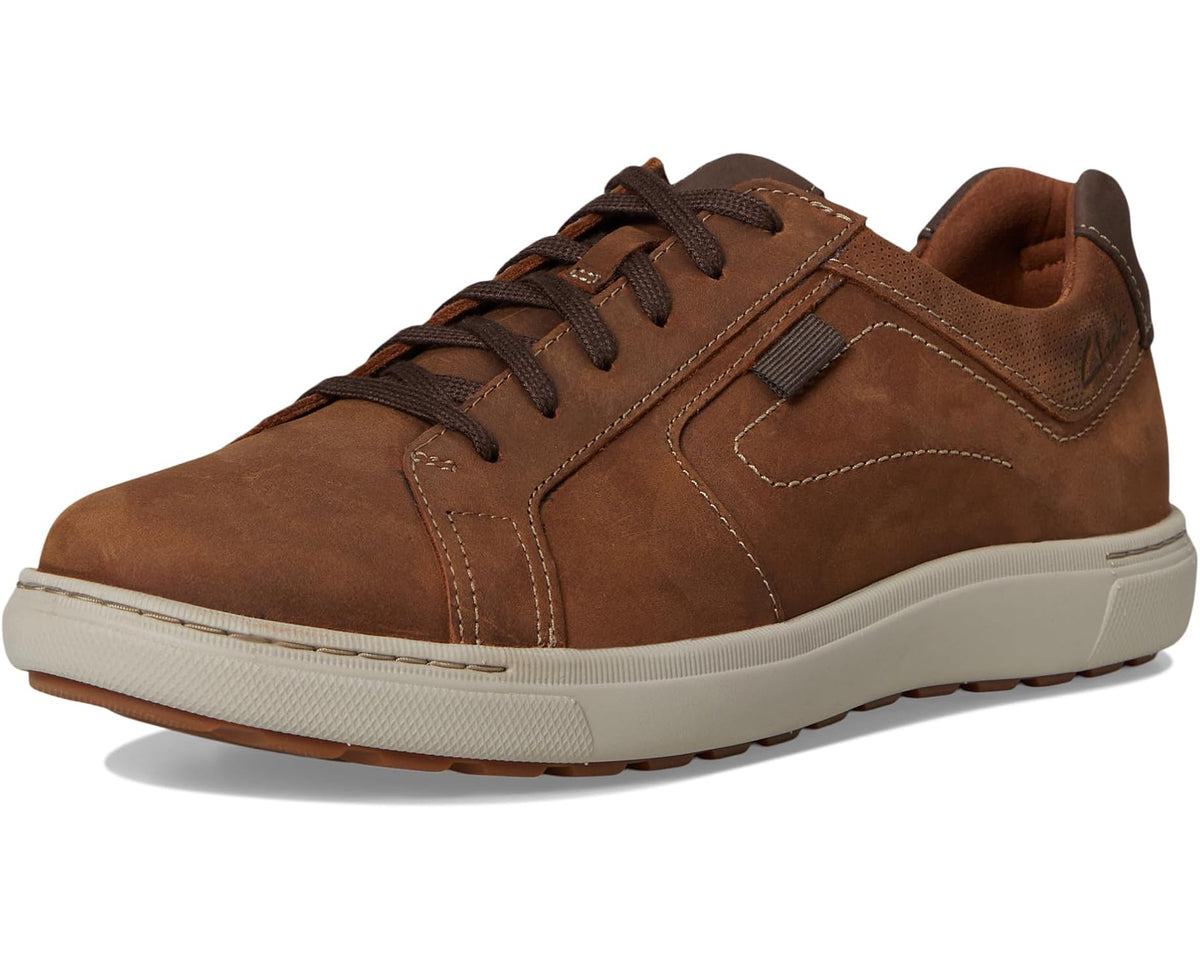 Brown lace-up sneaker with elastic side tab, contrast stitching, and white sole
