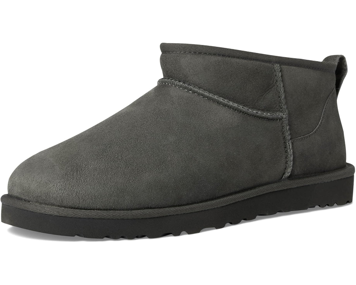 Dark gray suede ankle boot with UGG pull tab, low profile tread sole