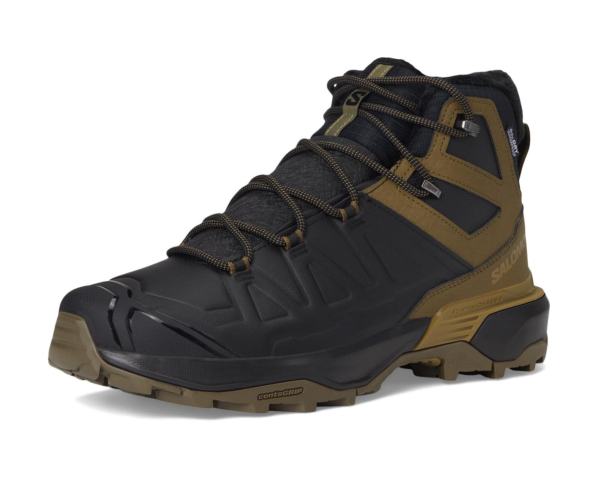Salomon men\u2019s snow hiking boot, angled view in black with olive accents and lugs