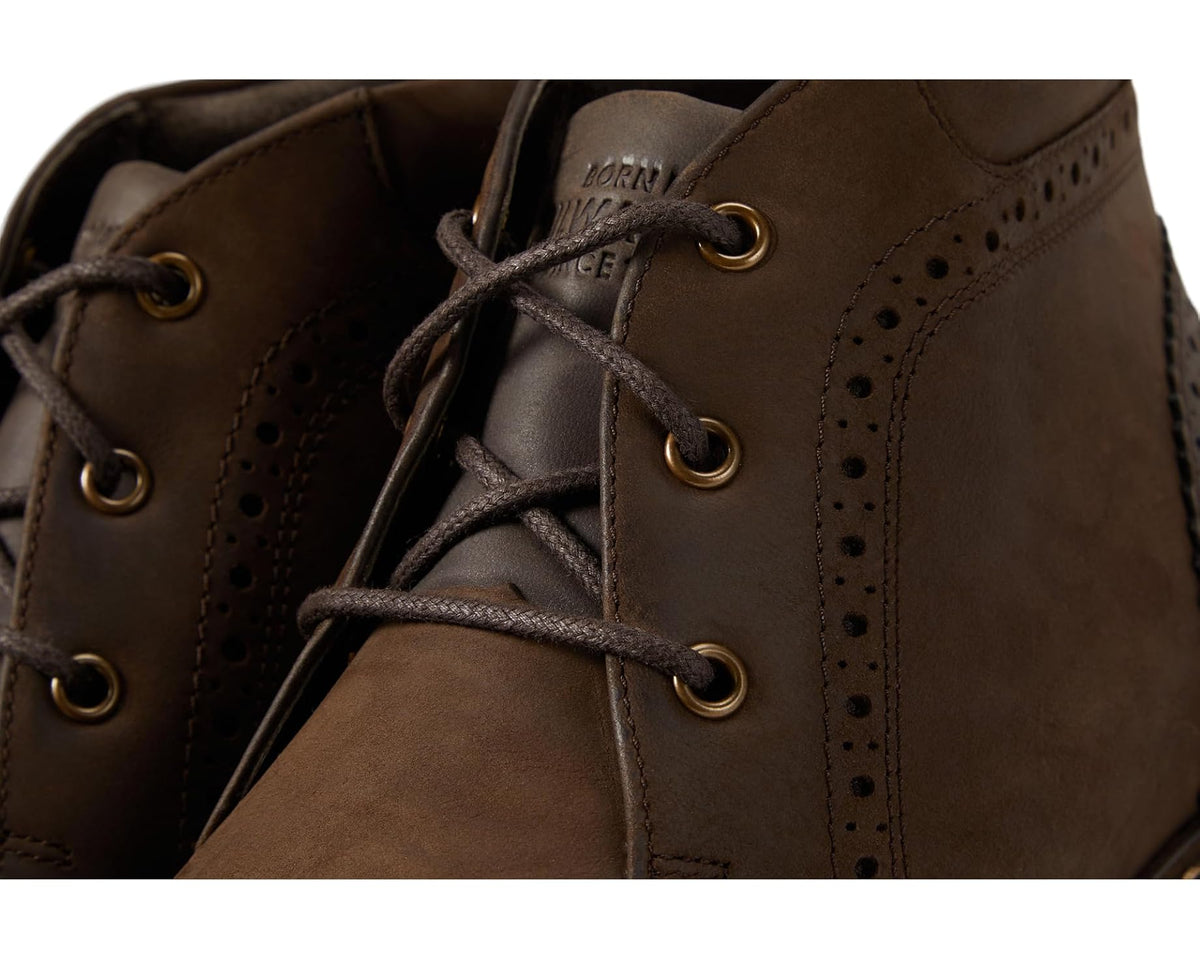 Brown leather chukka boot close-up with lace-up eyelets and side perforations