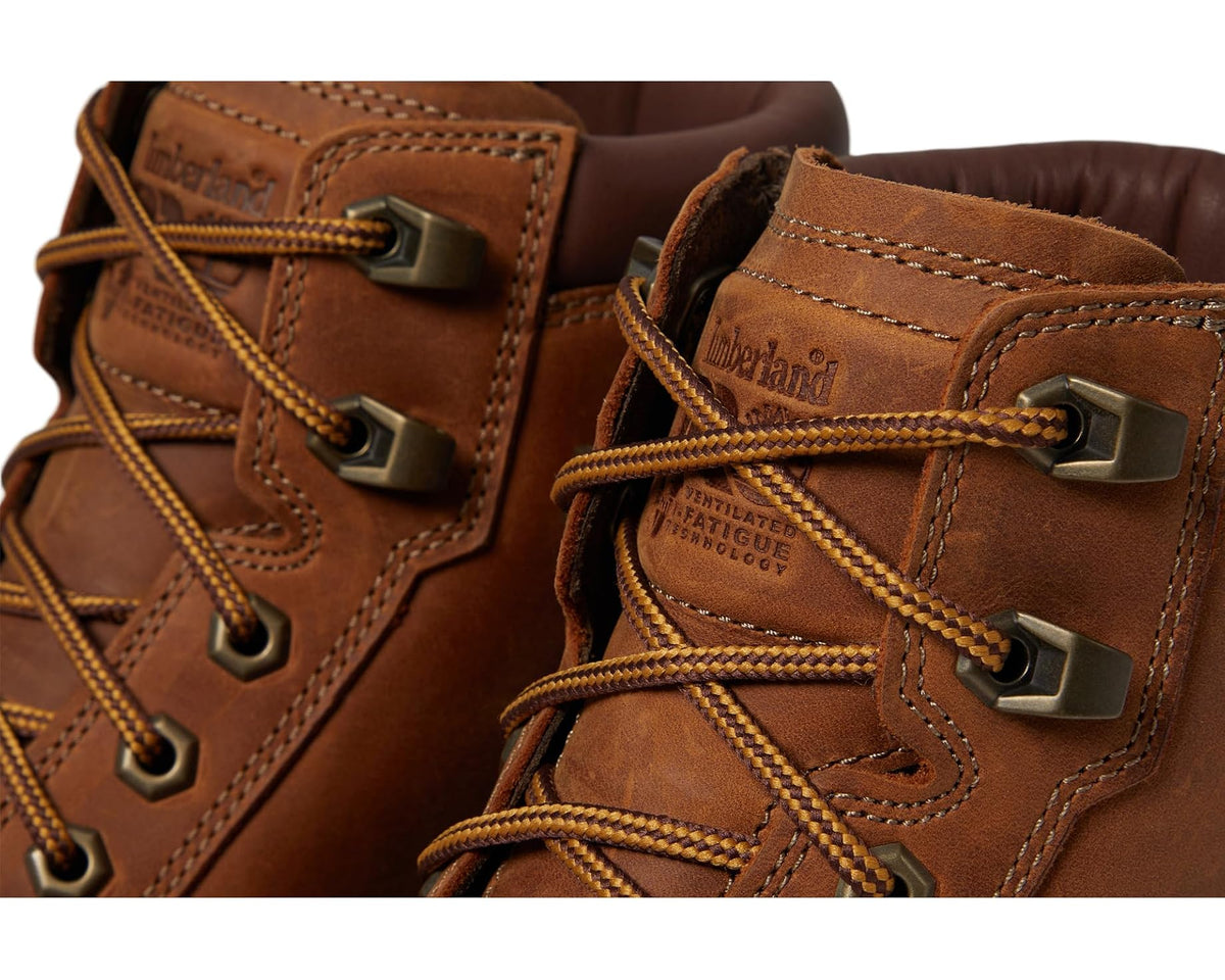 Brown leather boot close-up: metal lace hooks, stitched panels, textured outsole edge.