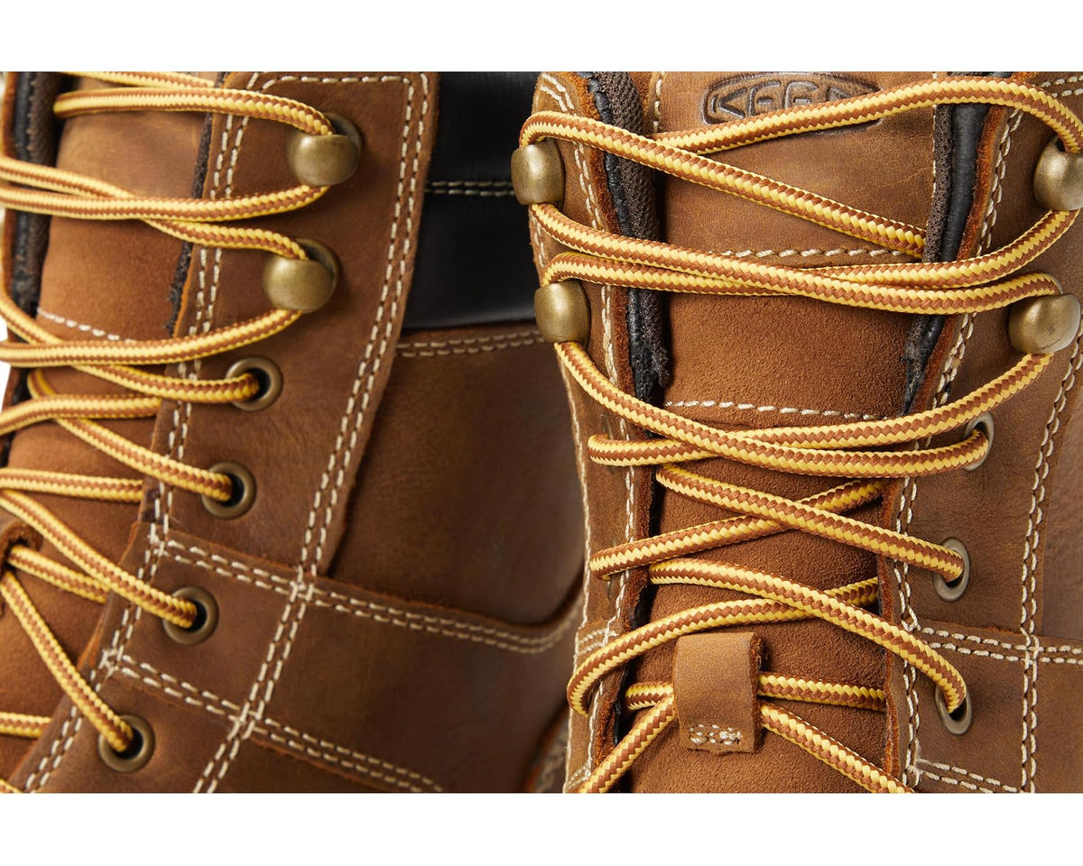 Close-up of brown boot laces, eyelets, and stitching on waterproof comp-toe work boot