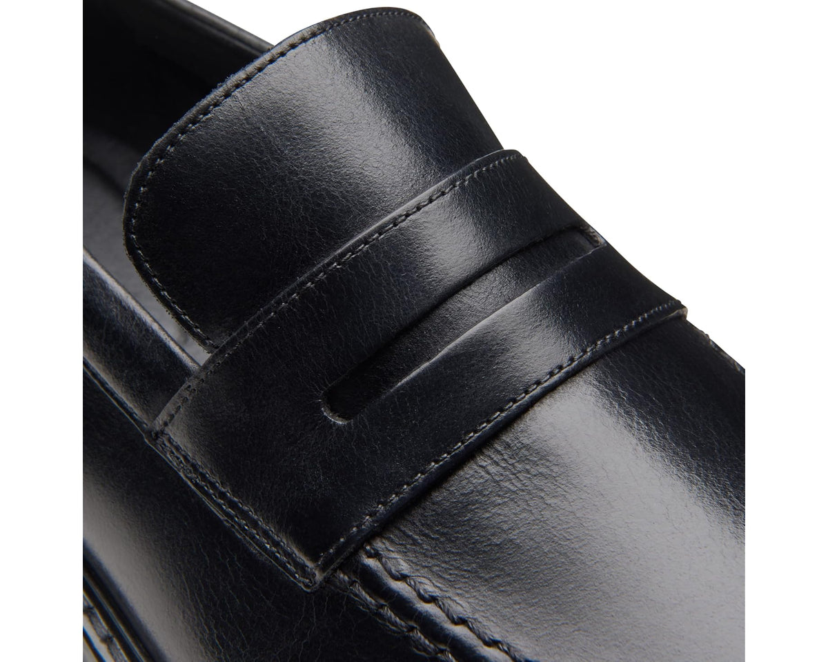 Close-up of black leather loafer strap with contrast stitching and slip-on opening