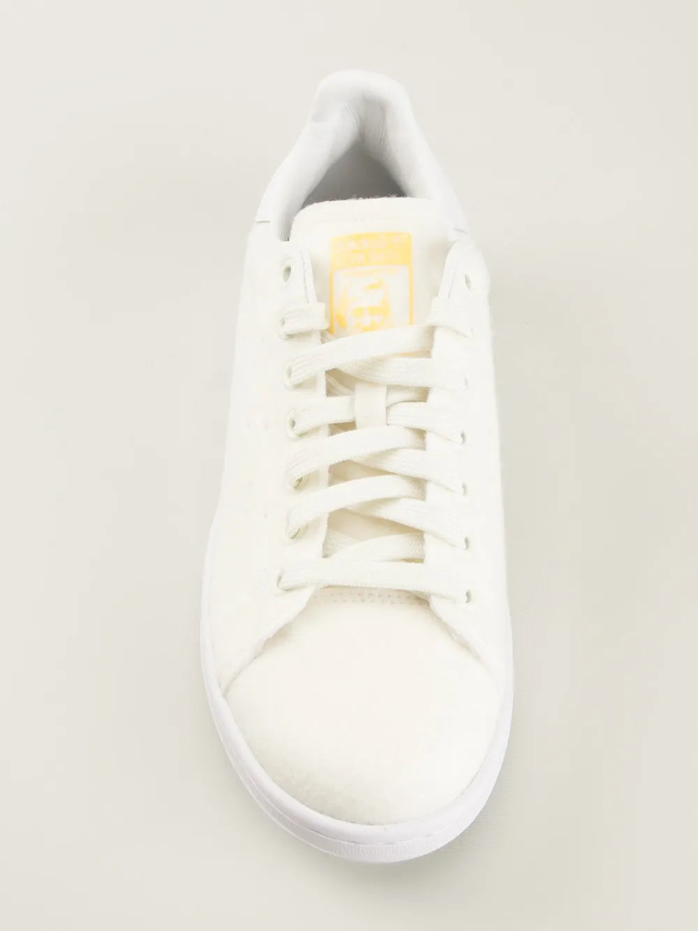 White lace-up sneakers with padded collar and striped tongue label