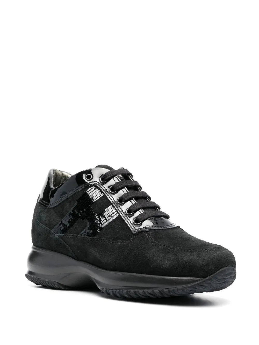 Black lace-up sneaker with metal eyelets, textured side stripe, and thick sole