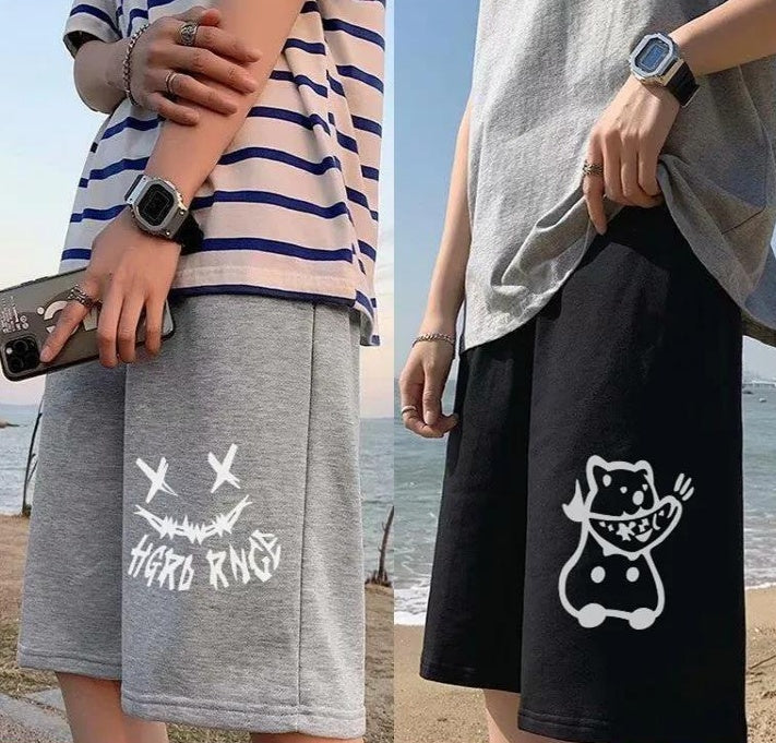Gray shorts with white skull-motif graphic; black shorts with white cartoon cat graphic