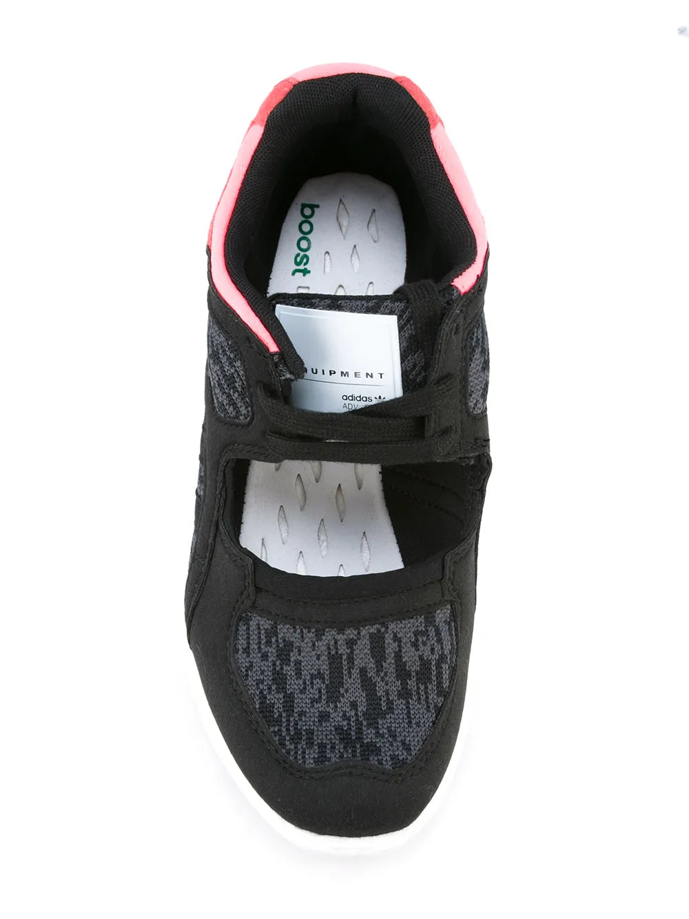 Black sneaker close-up with pink collar trim and cushioned insole detail
