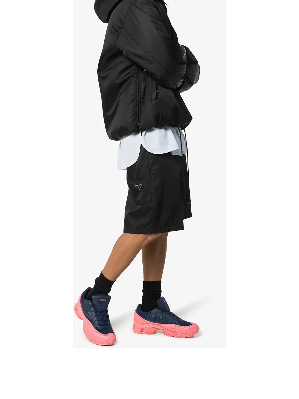 Navy blue and pink Ozweego sneakers on model, lace-up design