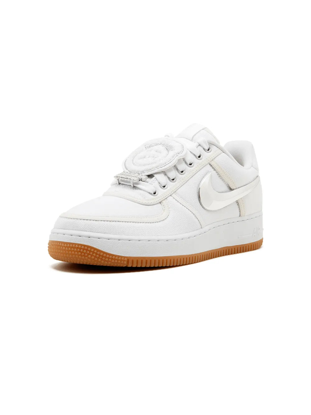 White low-top sneaker with circular tongue patch and gum rubber sole