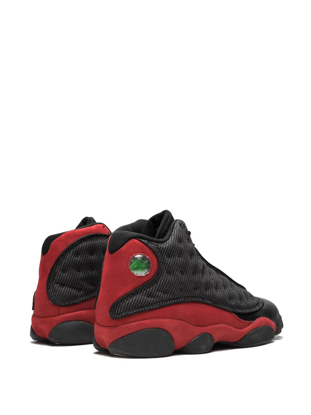 Black and red lace-up sneakers with green heel badge, textured upper, rubber sole