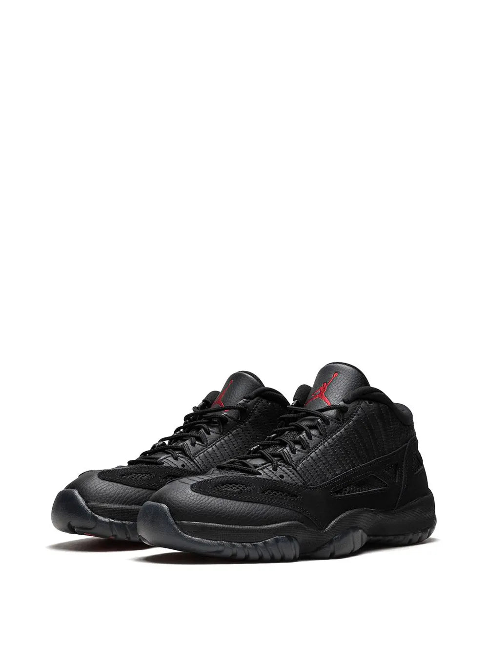 Black low-top sneakers shown from side, laces and stitched overlays visible