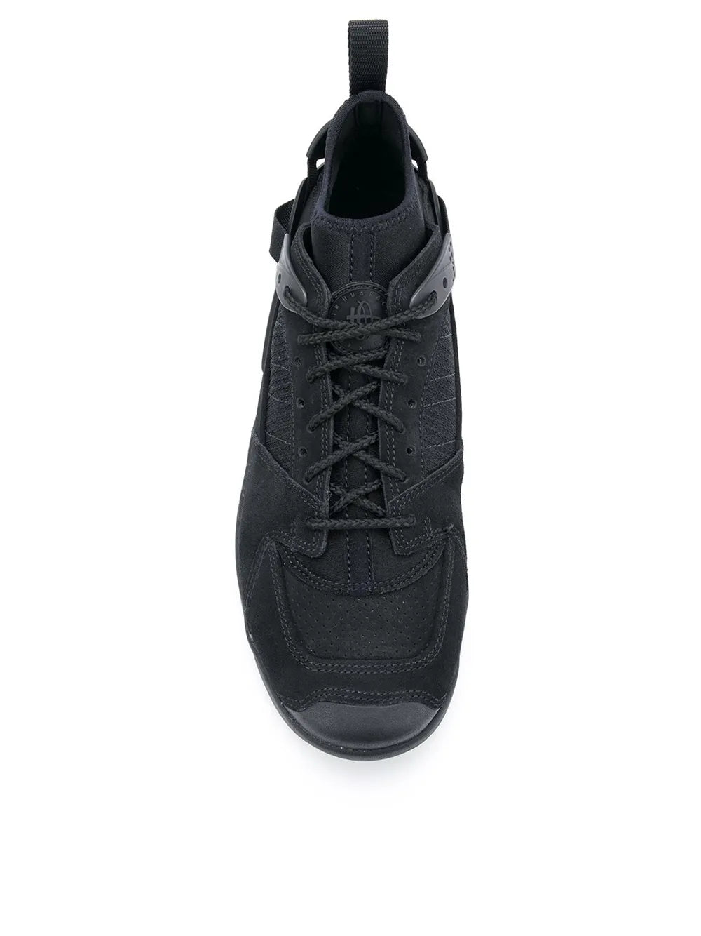 Nike black mid-top sneaker showing laces, tongue, and padded collar