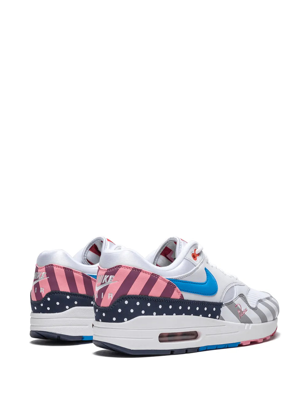 White sneakers with pink-and-navy heel panel, blue swoosh, striped toe, air sole