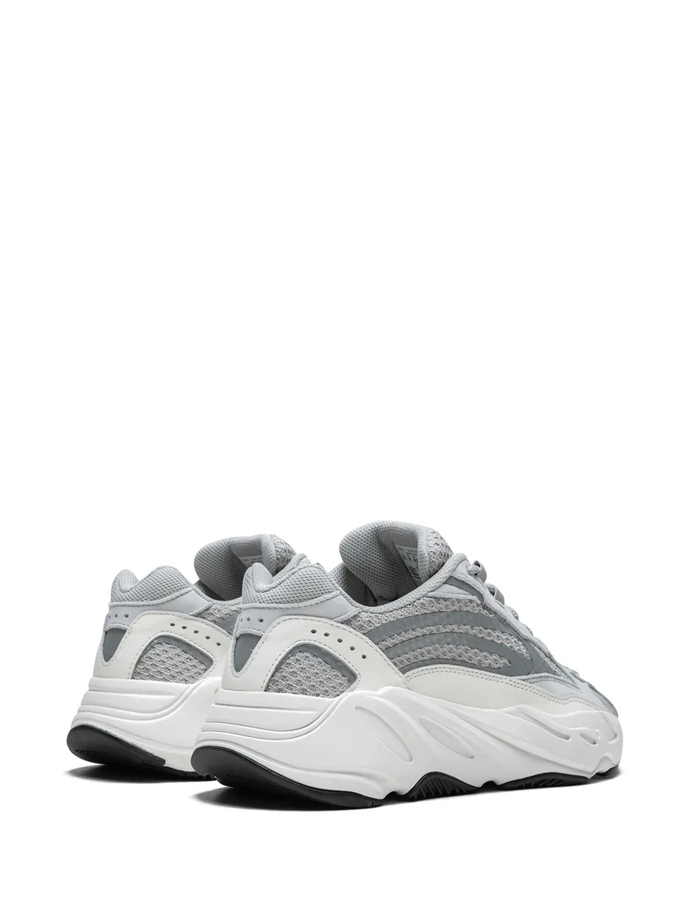 Grey and white lace-up sneaker, rear angle showing padded collar and chunky midsole