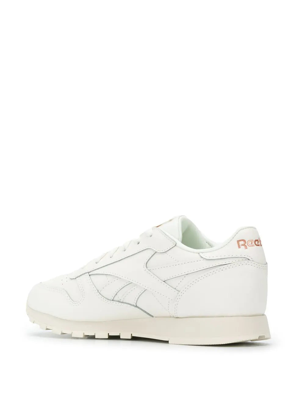 White Reebok sneakers side view with lace-up design and rubber outsole