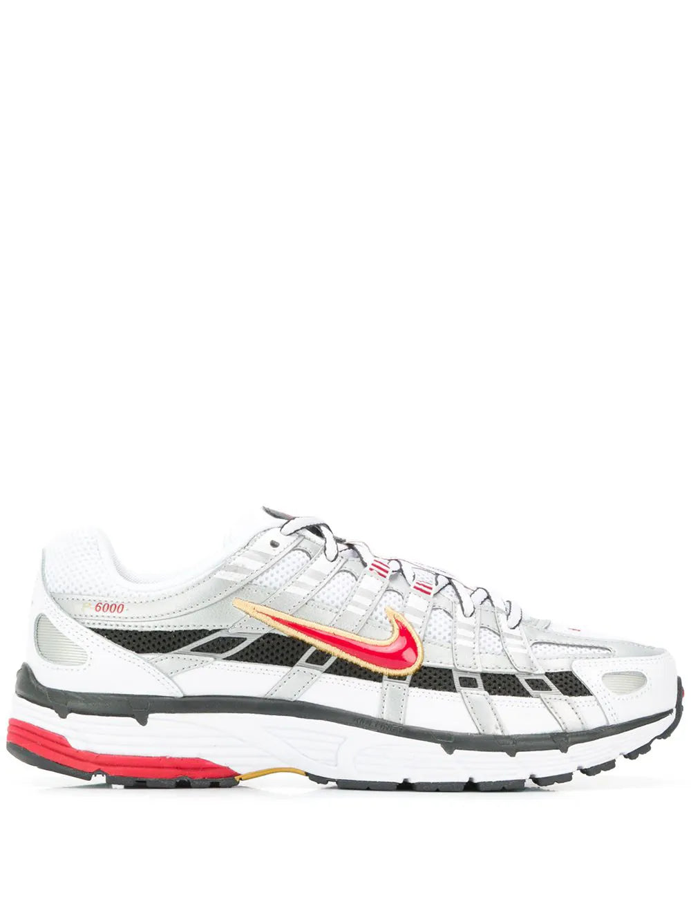 White low-top sneaker with Nike swoosh, black grid panels, red outsole accents.