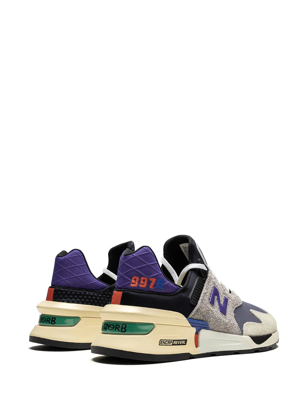 New Balance 997S sneakers showing purple heel and orange "997" detail with beige sole