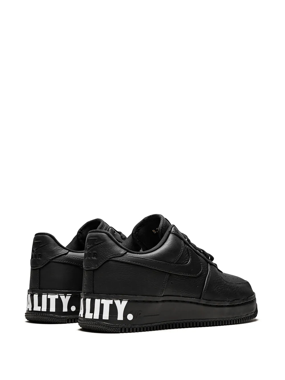 Black low-top sneakers with heel text detail and lace-up closure