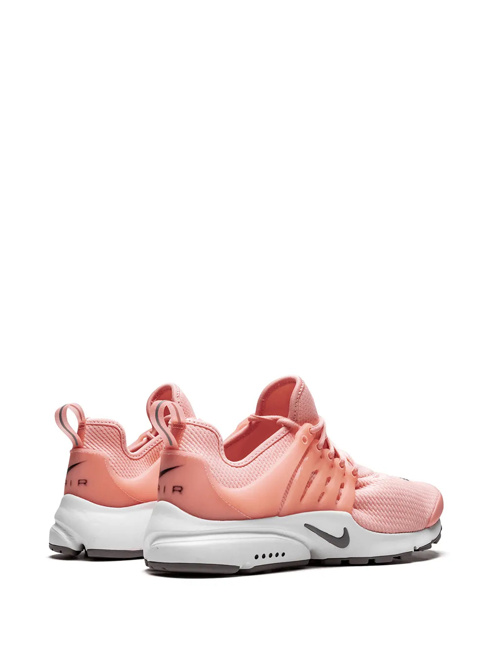 Pair of pink knit sneakers with white midsoles and side swoosh detail