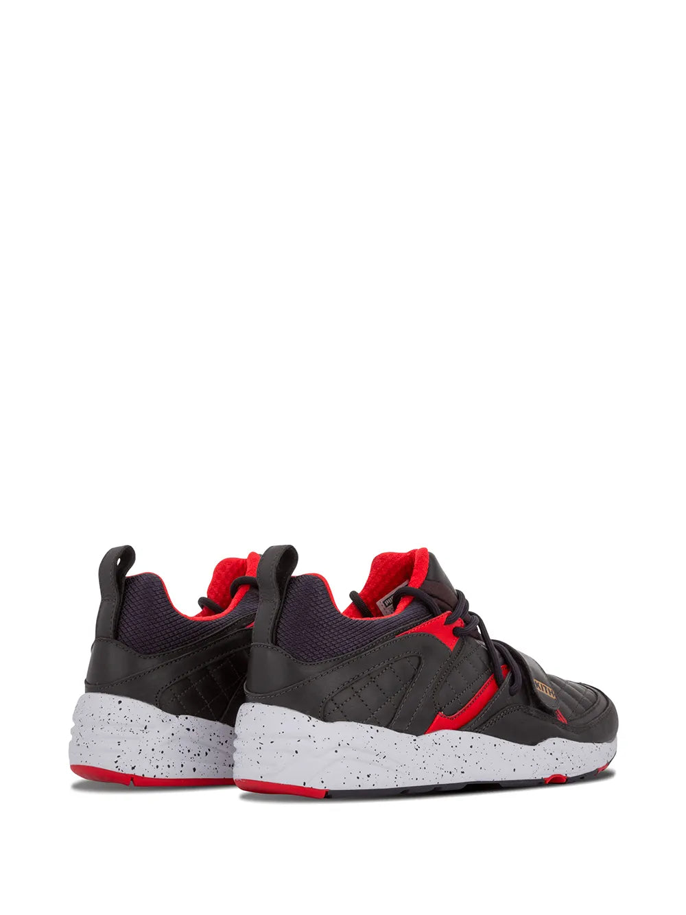Black lace-up sneakers with red accents and speckled midsole, side view
