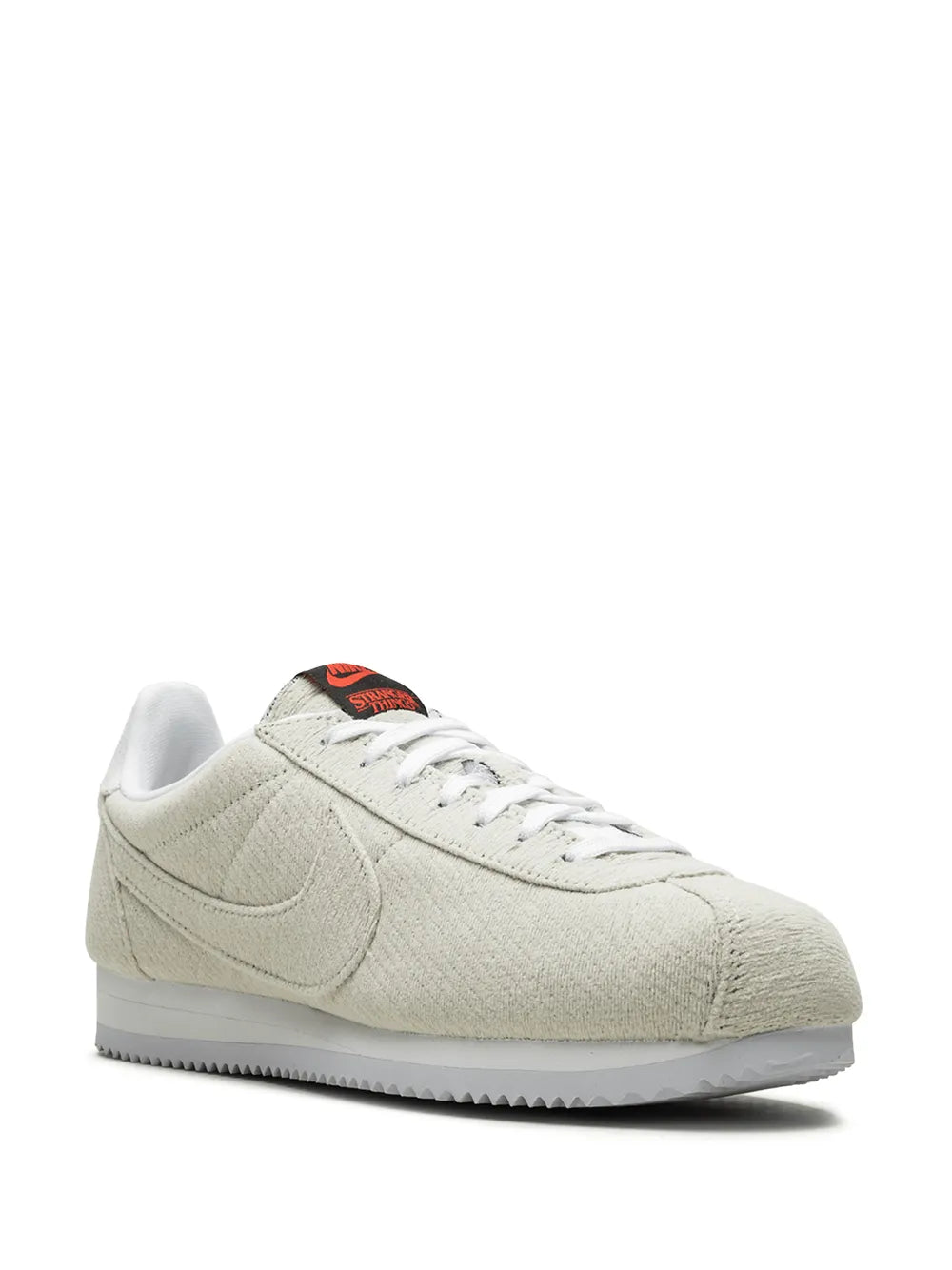 Tan Nike Cortez QS sneaker with white laces and red heel graphic