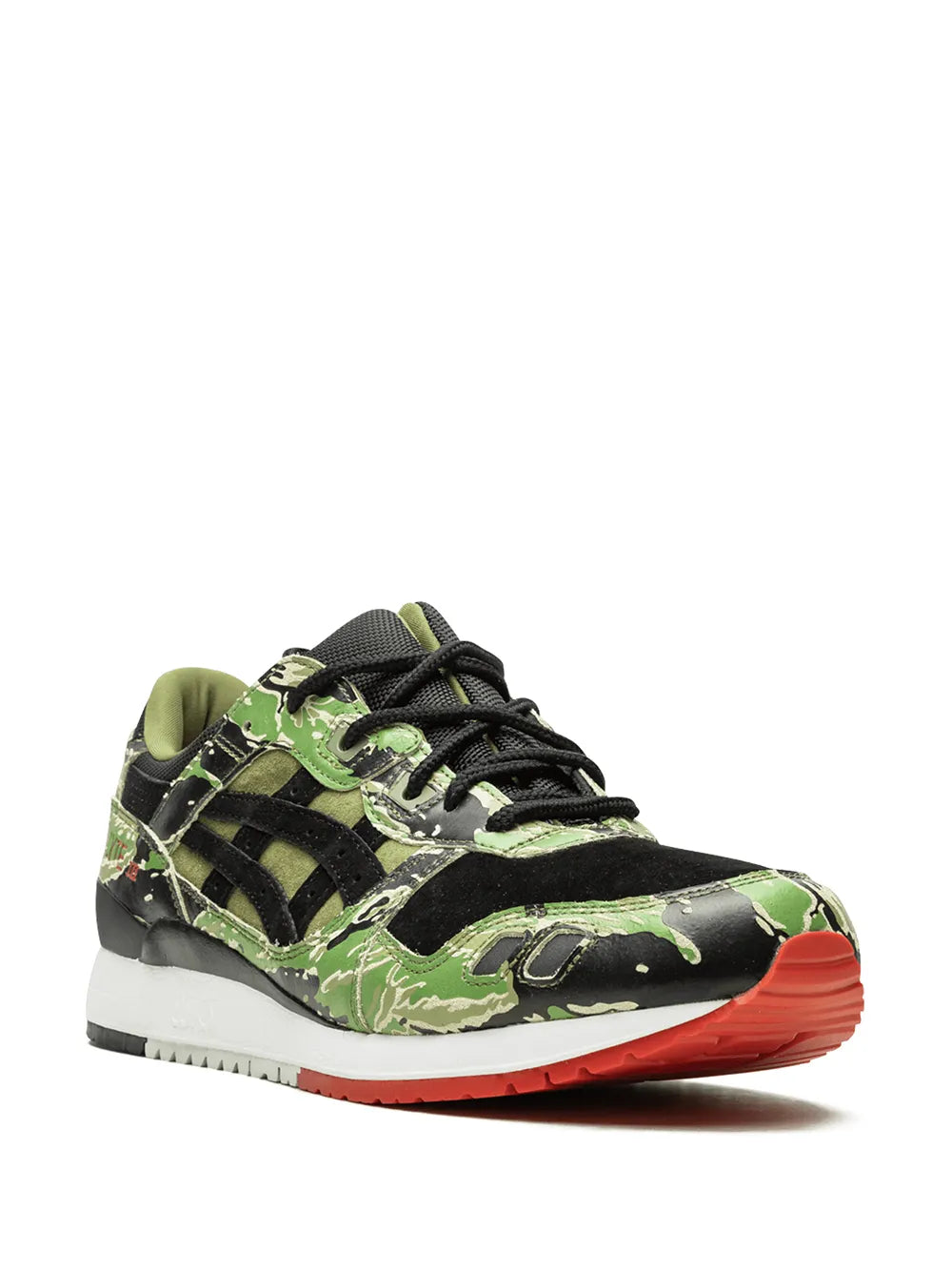 Low-top running sneaker with black and green camo panels, lace-up, red outsole edge