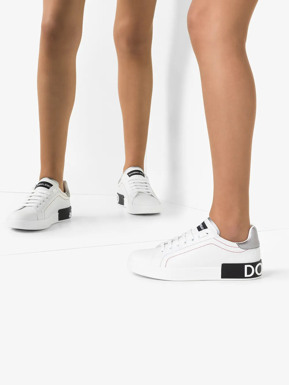 White leather low-top sneakers with gray heel detail and black logo