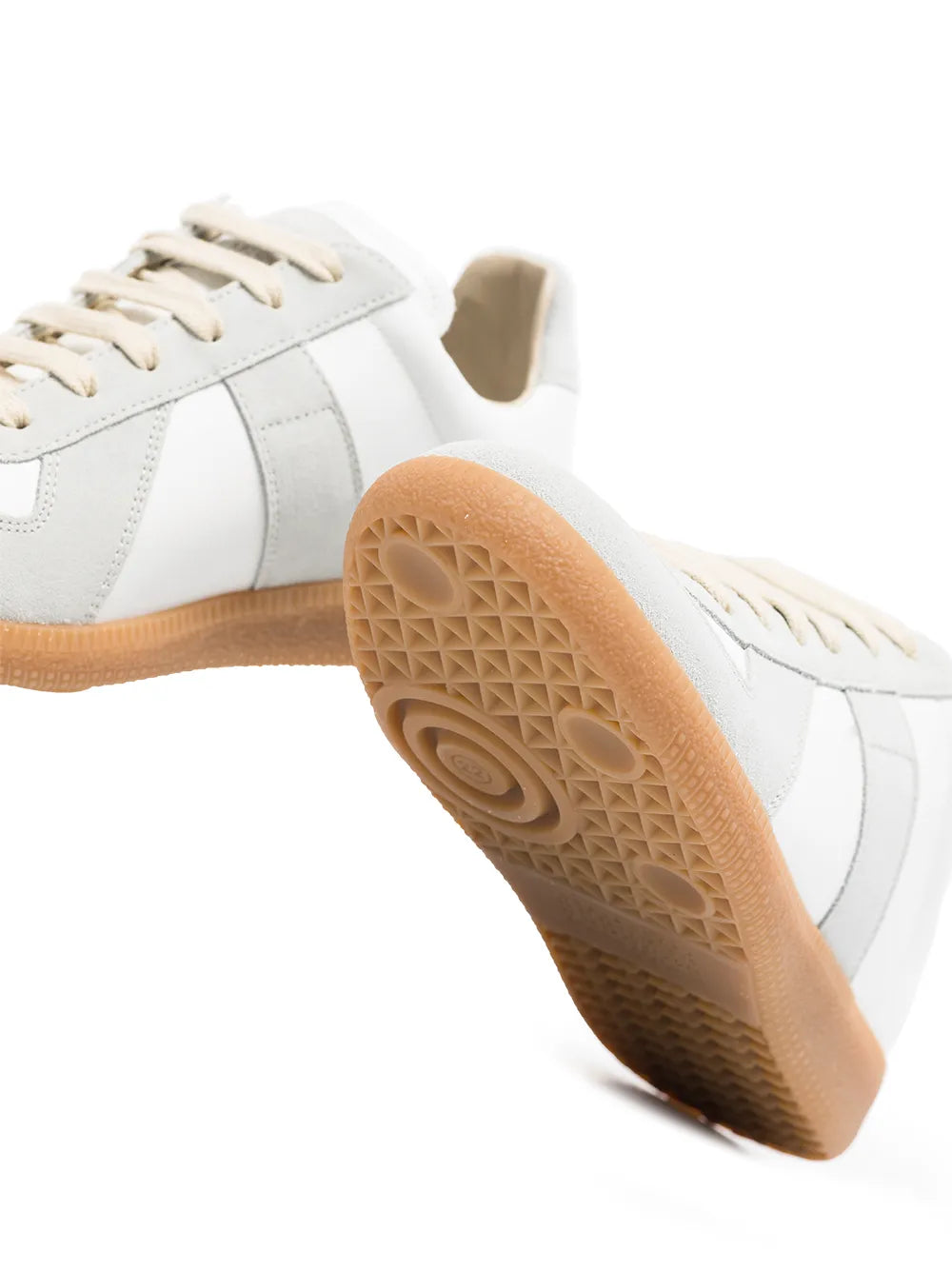White leather sneaker showing textured gum rubber outsole tread